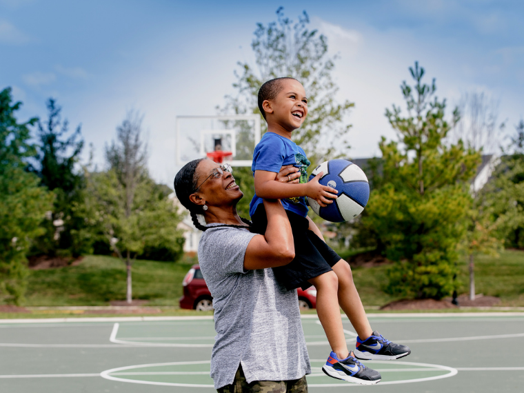 Parent and child enjoying a game of basketball
