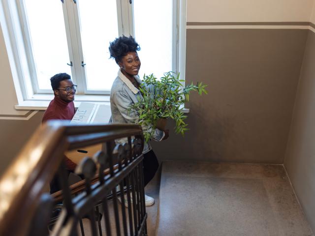 Man and woman moving into new apartment building