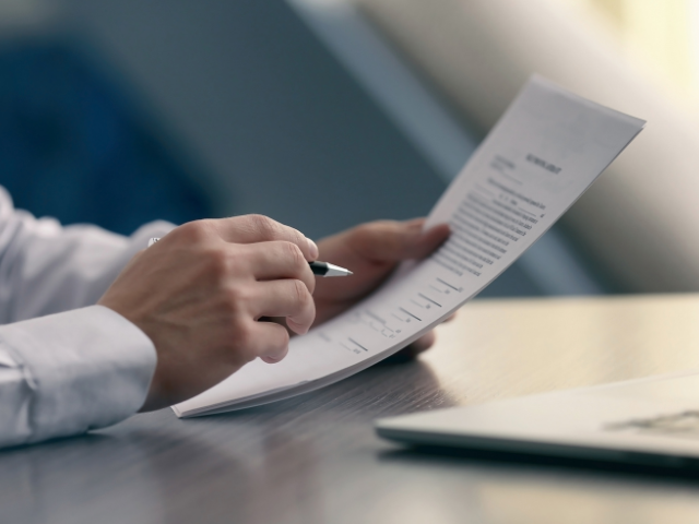 Person holding up document