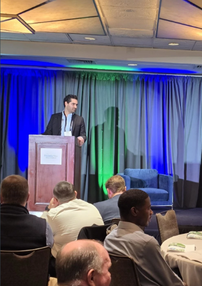 Christopher speaking at a Freddie Mac event