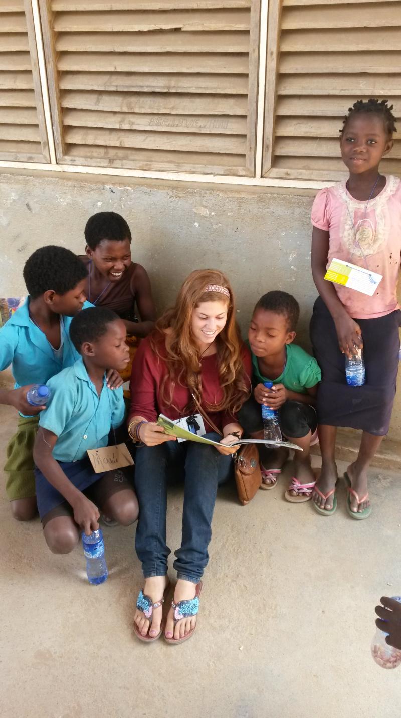 Rebekah reading to children in Tete